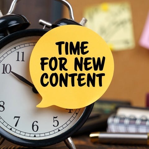 Clock face stating time for new content
