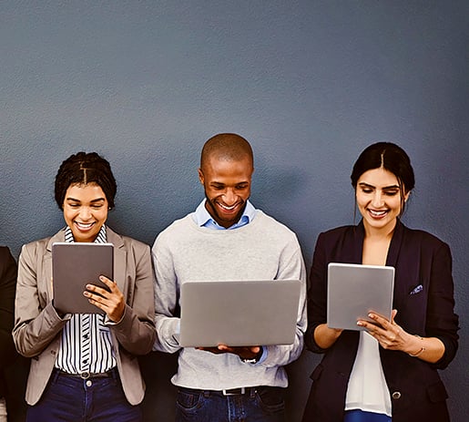 A Group of men and women looking at digital devices
